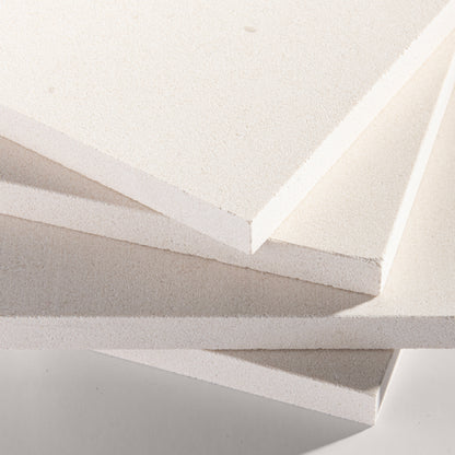 close angle of tiles with a white limestone pattern on a white background