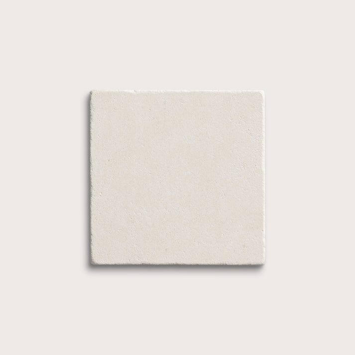 square tile with a white limestone pattern on a white background