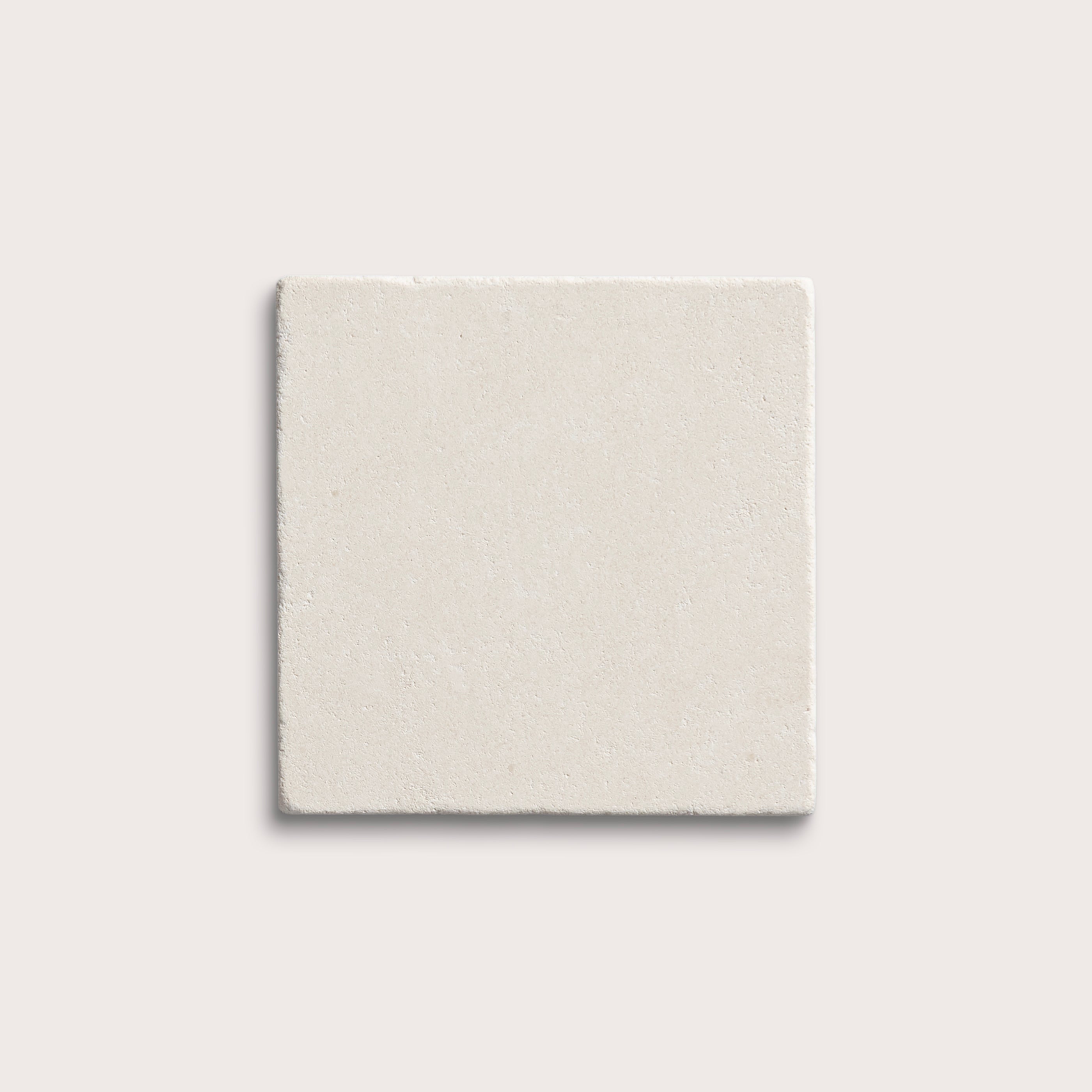 square tile with a white limestone pattern on a white background