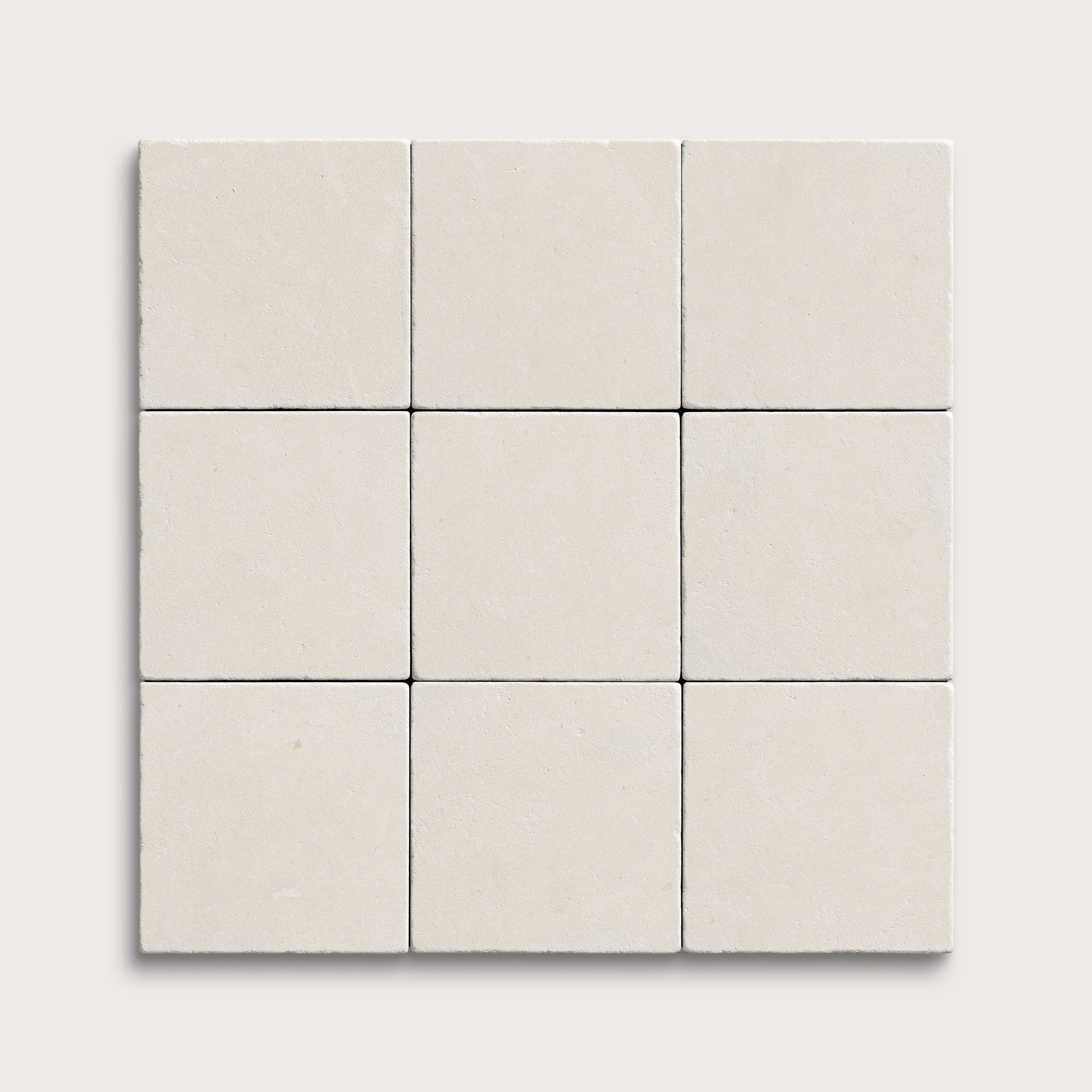 nine square tiles with a white limestone pattern on a white background