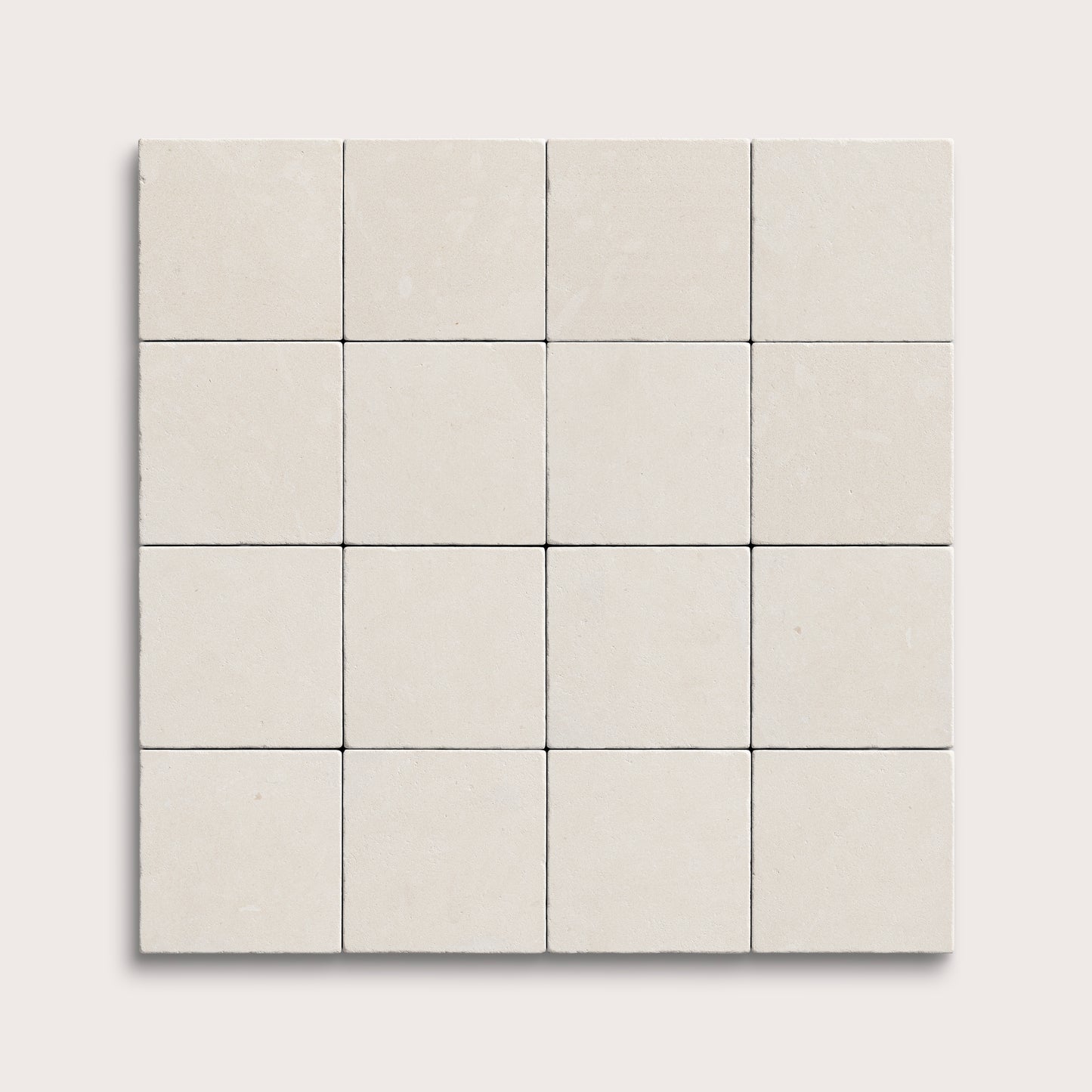 sixteen square tiles with a white limestone pattern on a white background