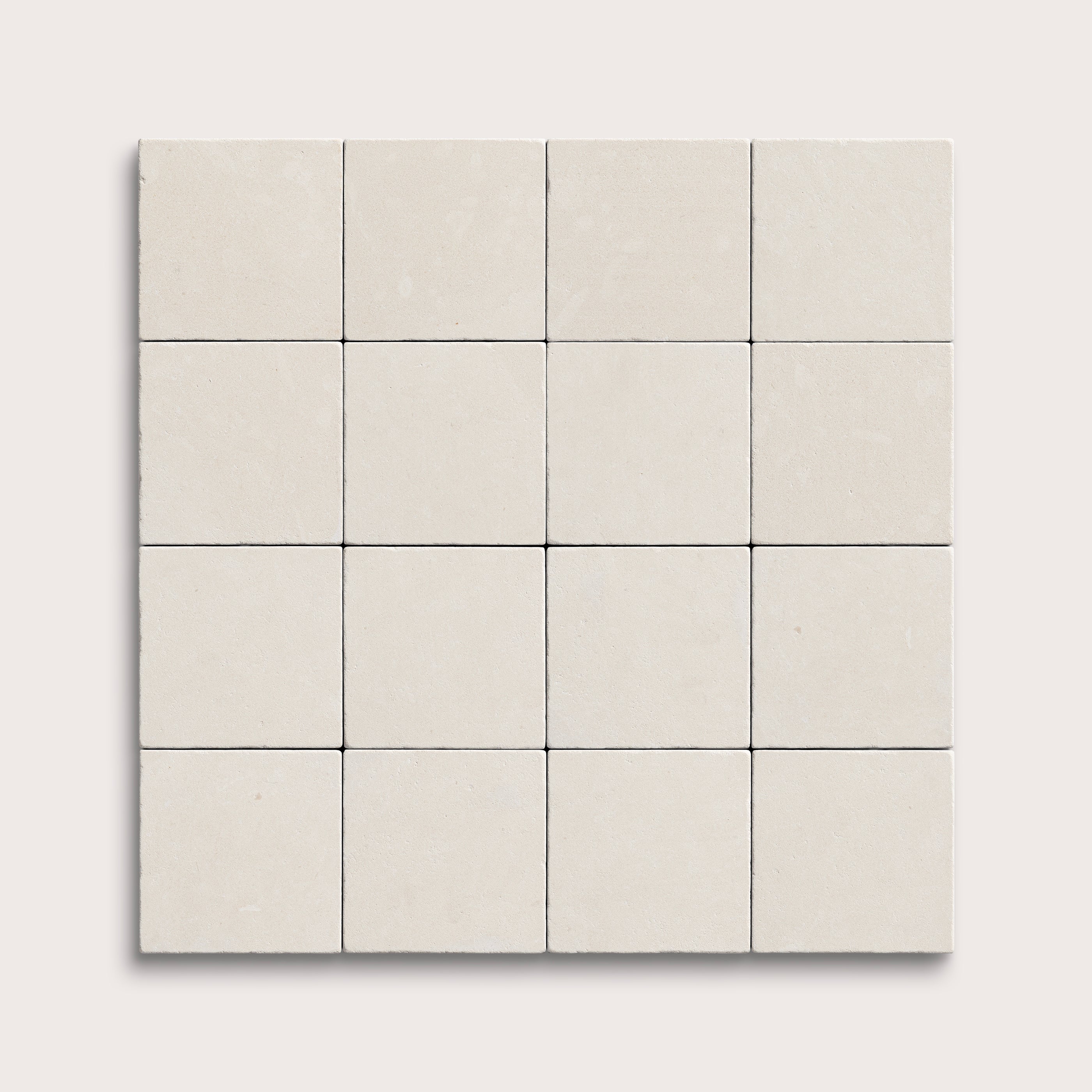 sixteen square tiles with a white limestone pattern on a white background