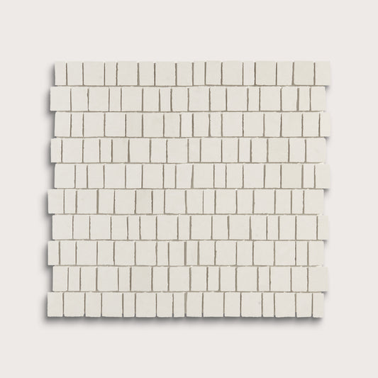 A square sample of small rectangular off-white mosaic tiles arranged in staggered rows, shown on a light warm gray background.