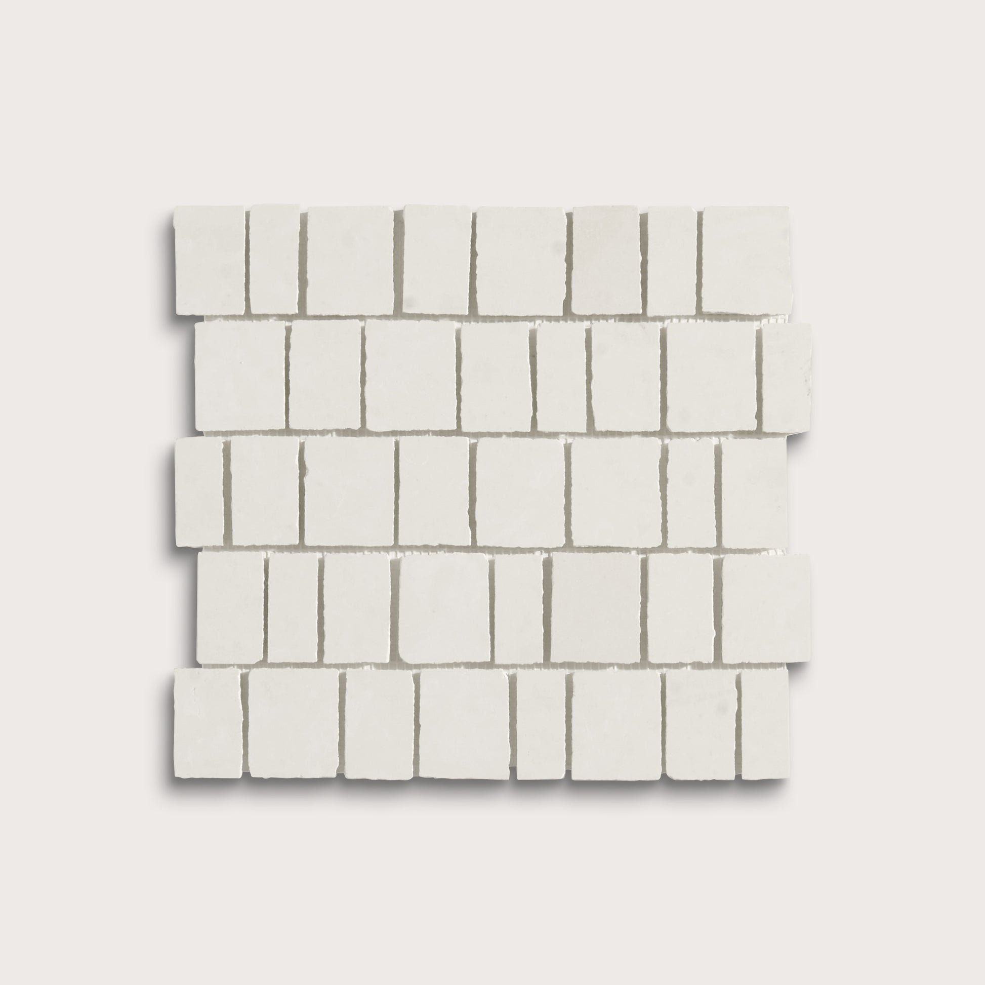White rectangular mosaic tile sheets arranged in a staggered brick pattern on a light gray background.