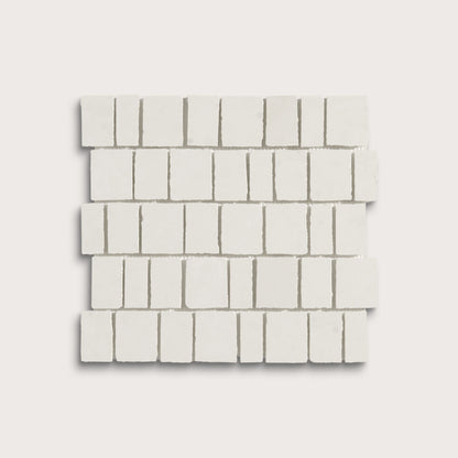 White rectangular mosaic tile sheets arranged in a staggered brick pattern on a light gray background.