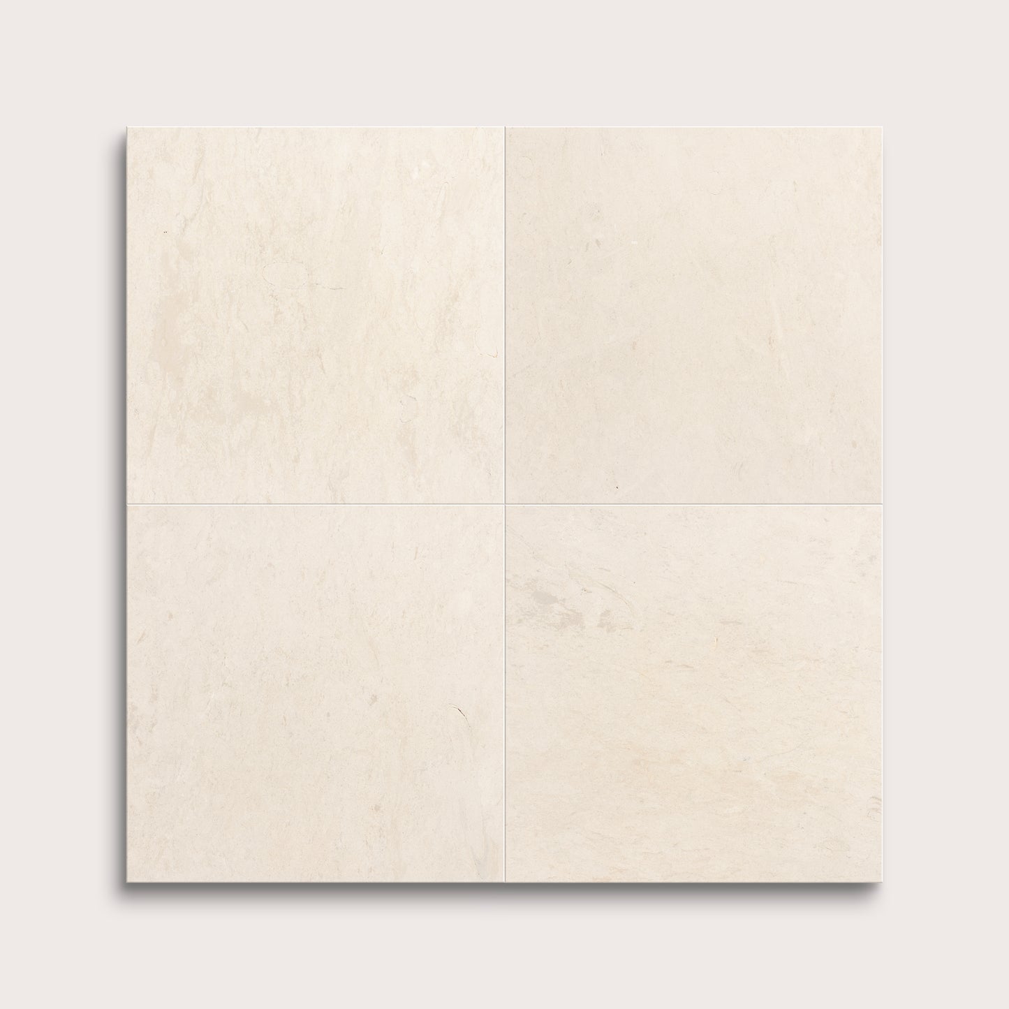 four square tiles with a beige limestone pattern on a white background