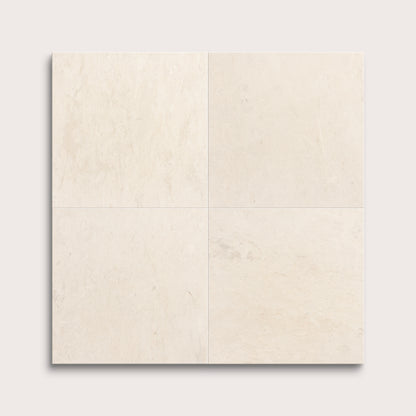 four square tiles with a beige limestone pattern on a white background