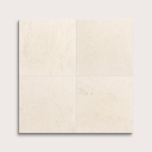 four square tiles with a beige limestone pattern on a white background