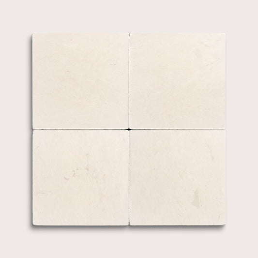 four square tiles with a beige limestone pattern on a white background