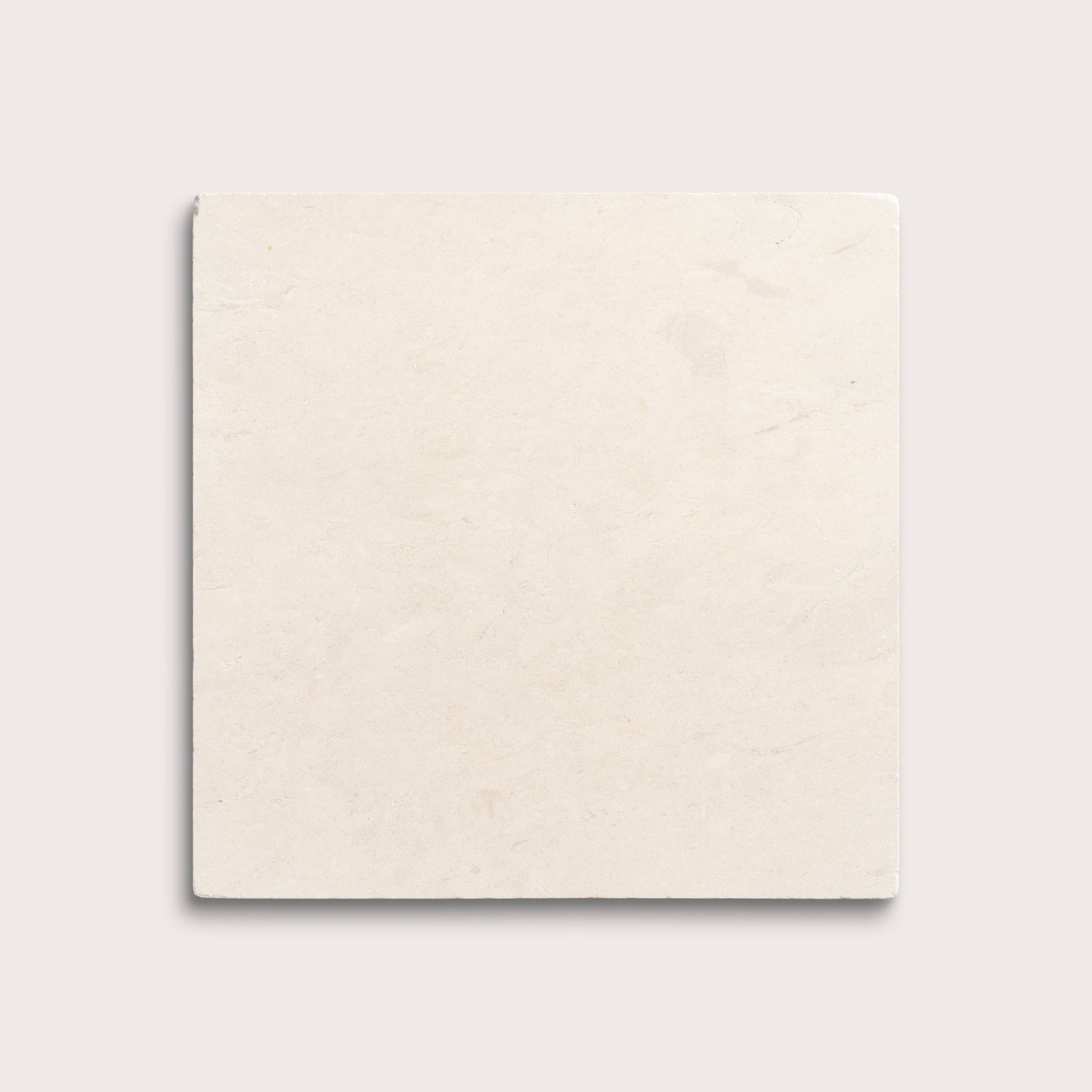 square tile with a beige limestone pattern on a white background