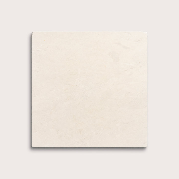 square tile with a beige limestone pattern on a white background