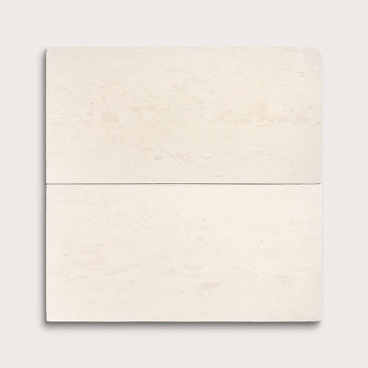 two rectangle tiles with a beige limestone pattern on a white background