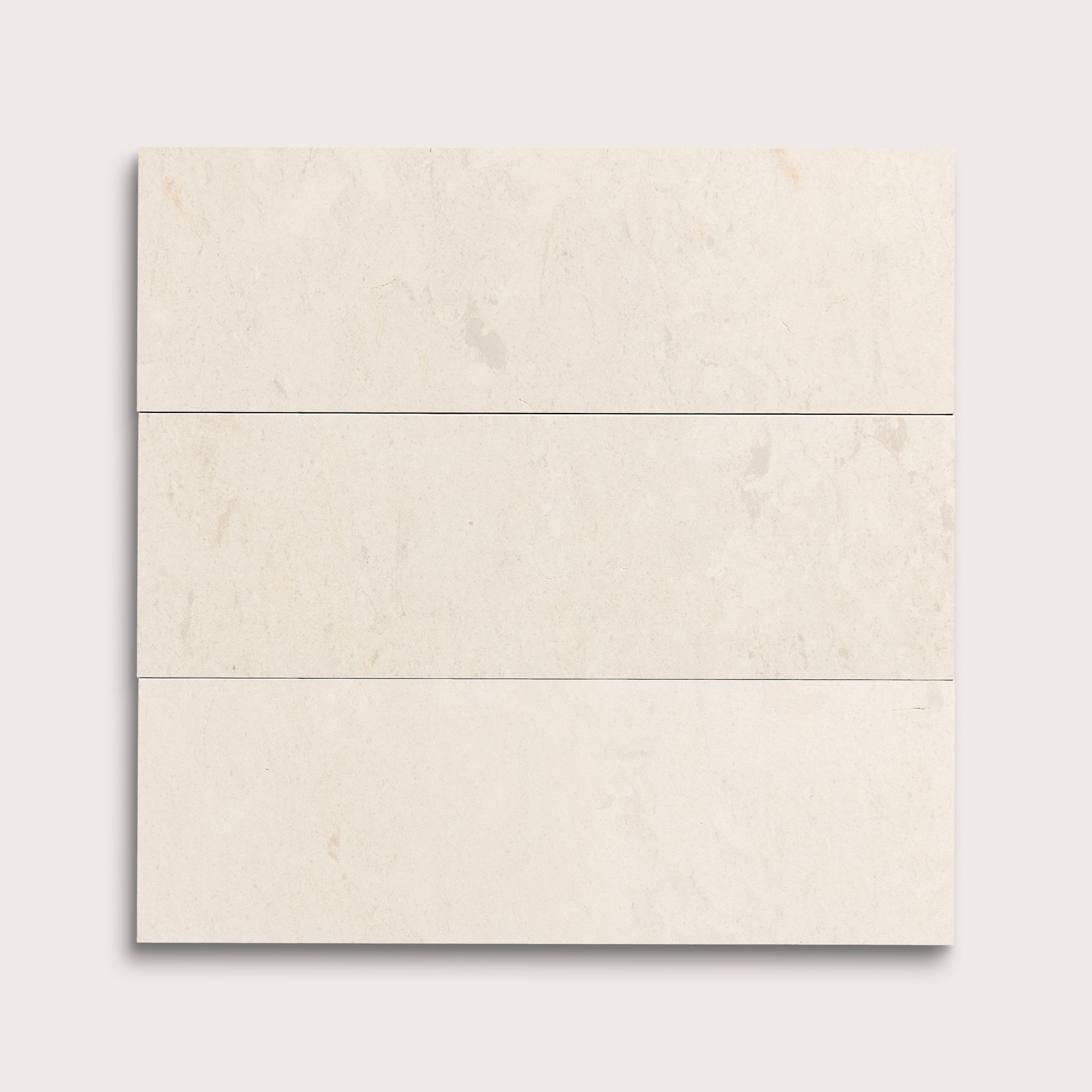 three rectangle tiles with a beige limestone pattern on a white background