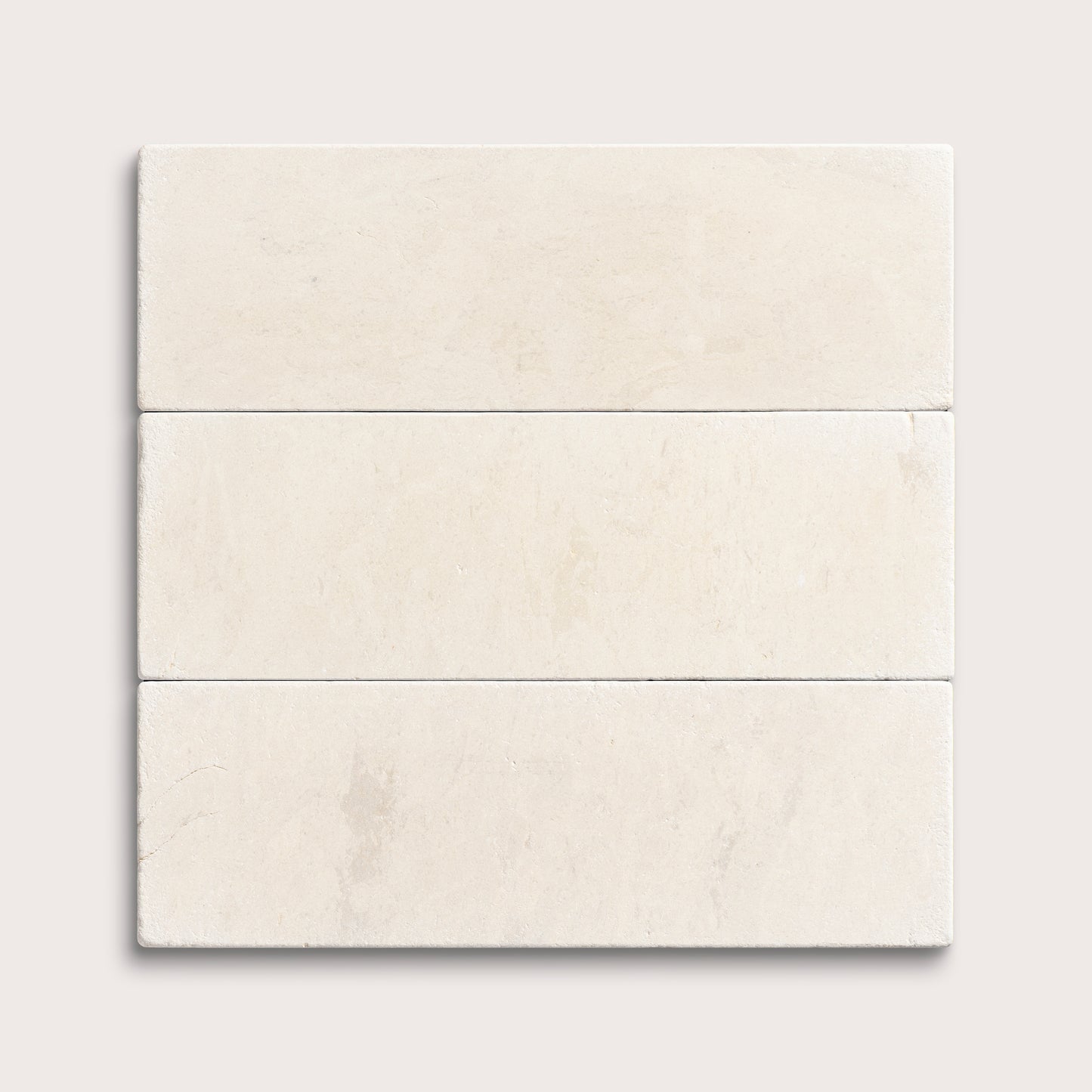 three rectangle tiles with a beige limestone pattern on a white background