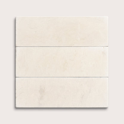 three rectangle tiles with a beige limestone pattern on a white background