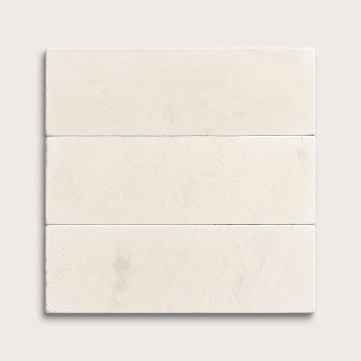 three rectangle tiles with a beige limestone pattern on a white background