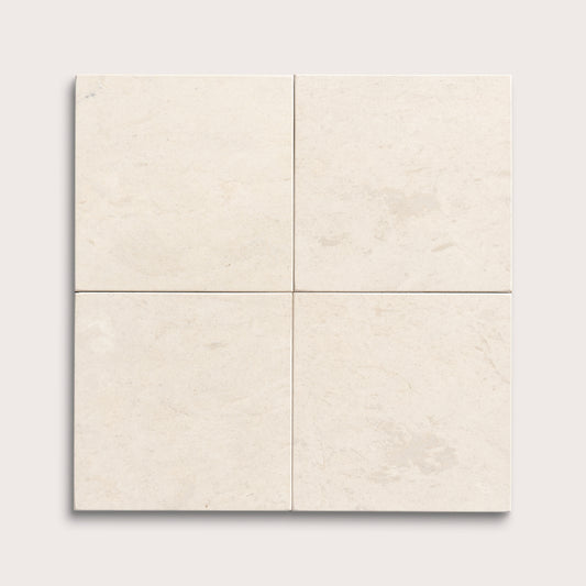 four square tiles with a beige limestone pattern on a white background