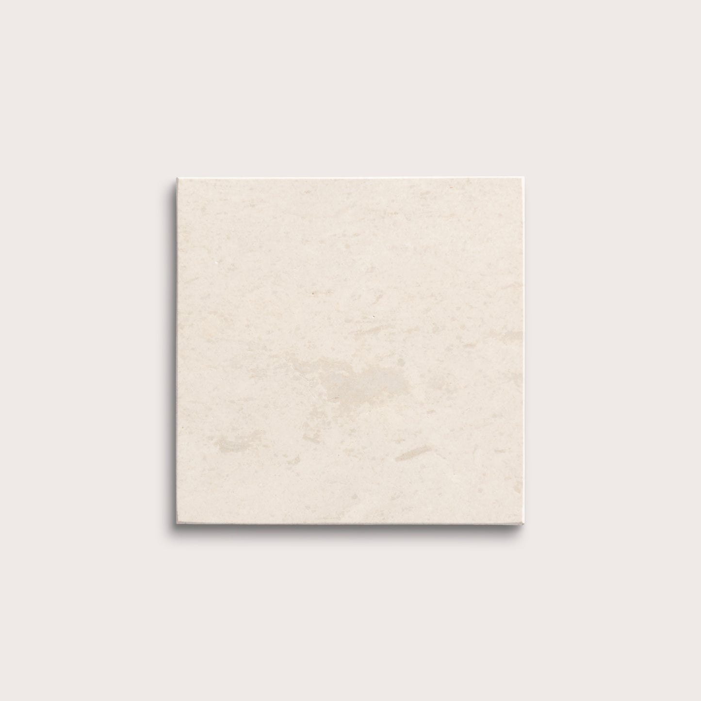 square tile with a beige limestone pattern on a white background