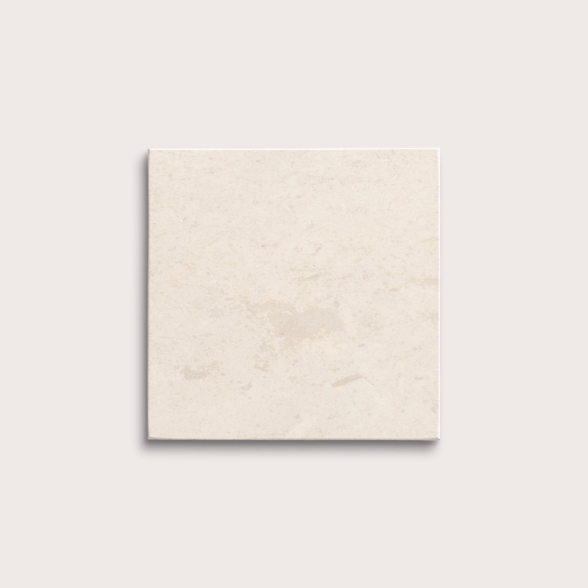 square tile with a beige limestone pattern on a white background