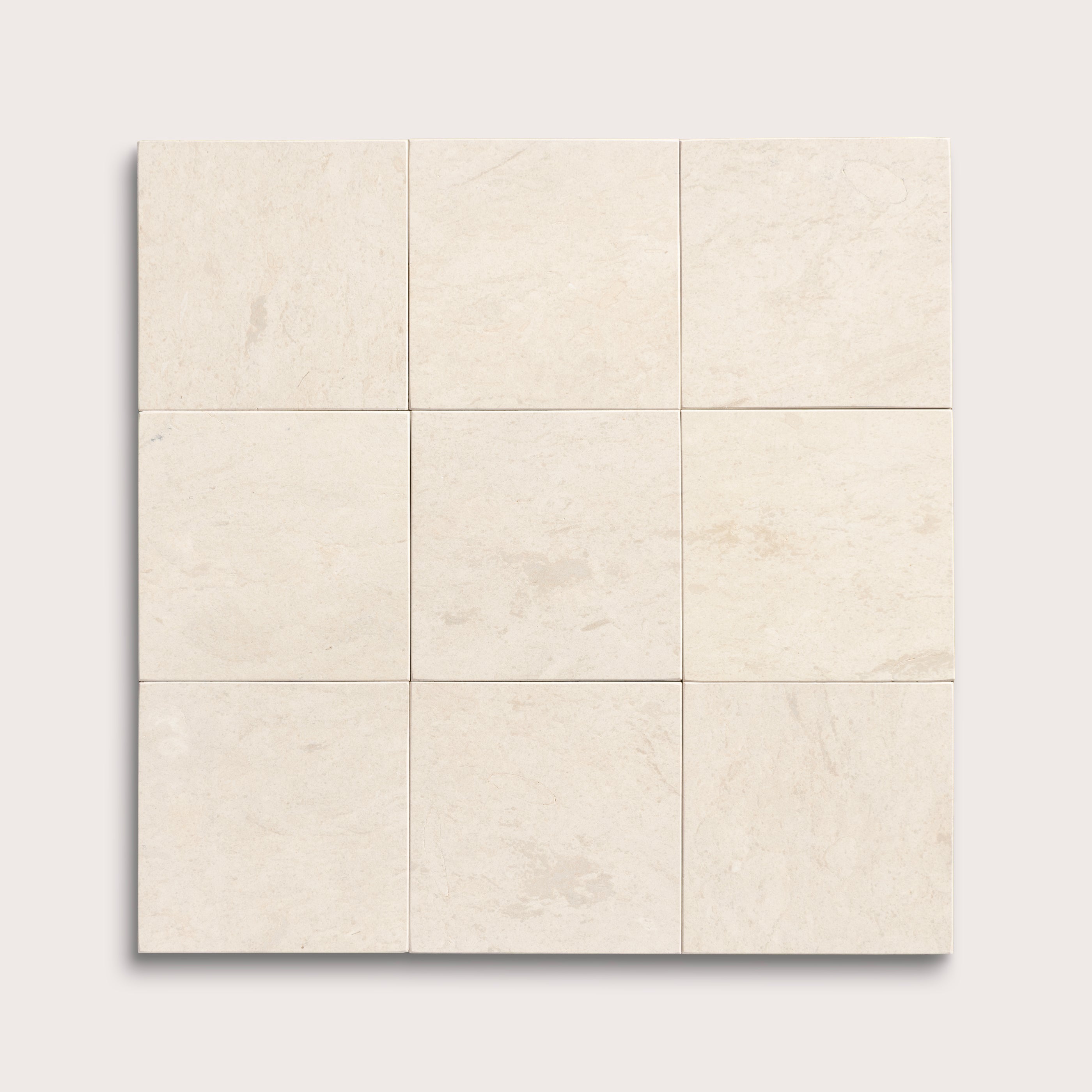 nine square tiles with a beige limestone pattern on a white background
