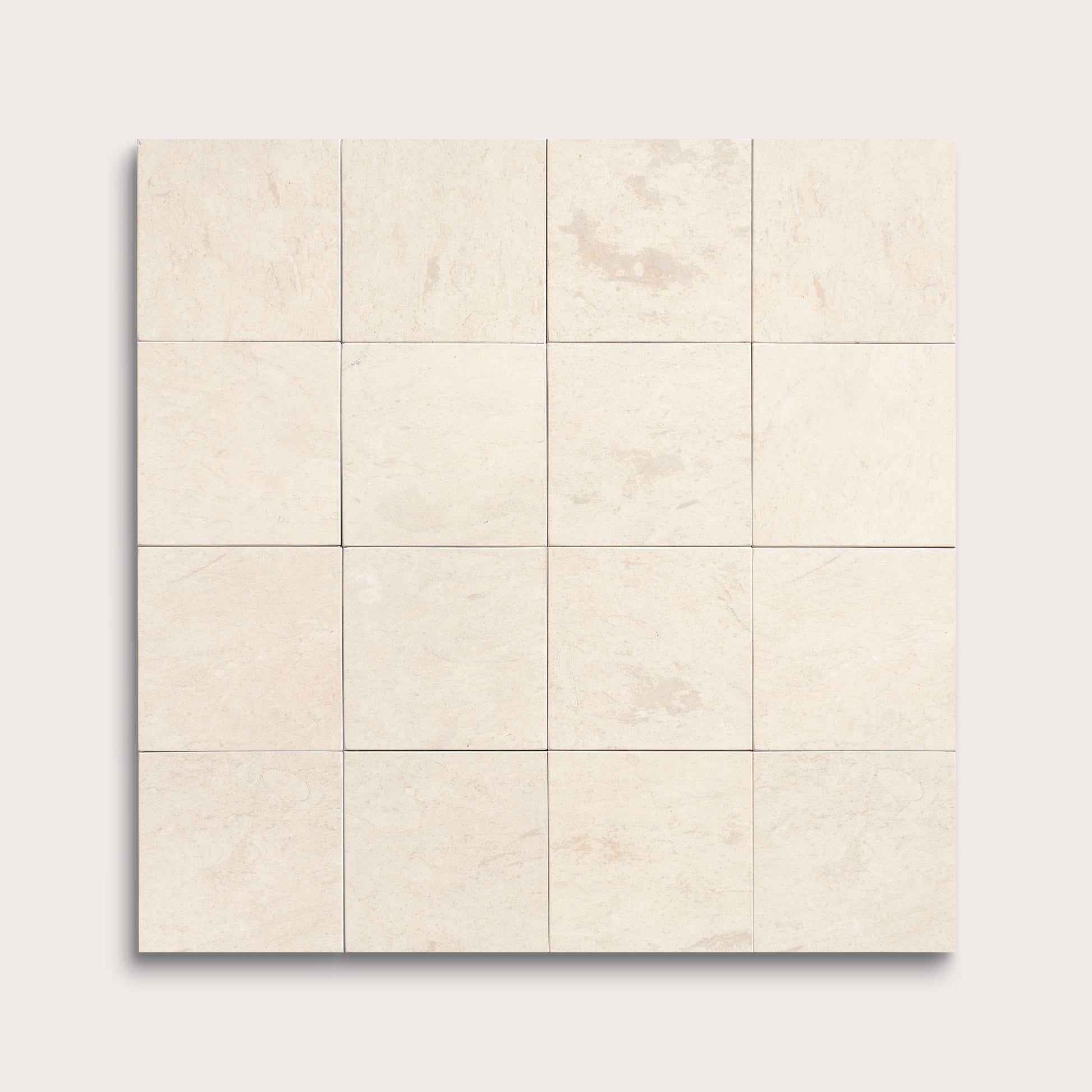 sixteen square tiles with a beige limestone pattern on a white background