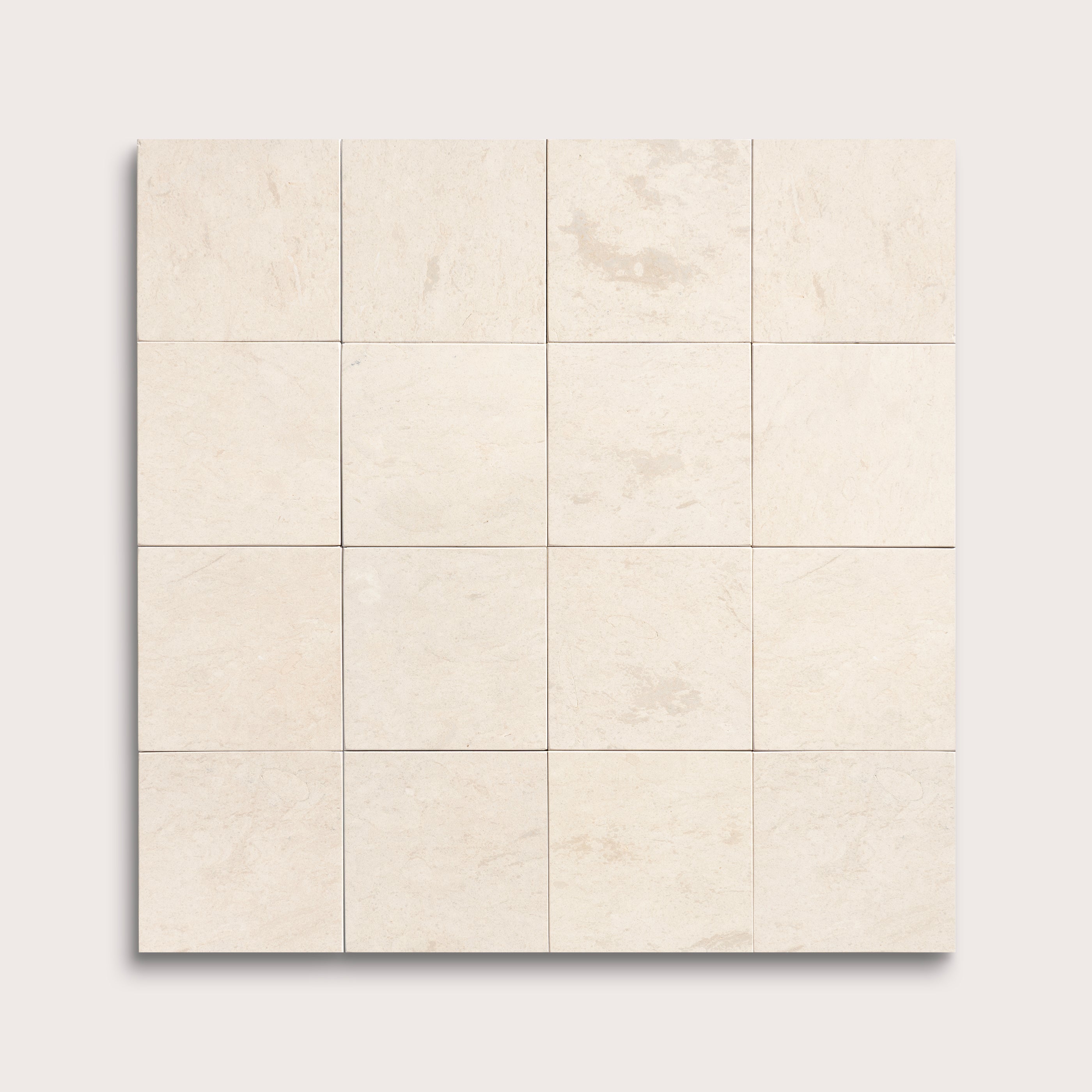 sixteen square tiles with a beige limestone pattern on a white background