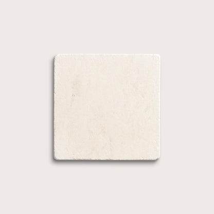 square tile with a beige limestone pattern on a white background