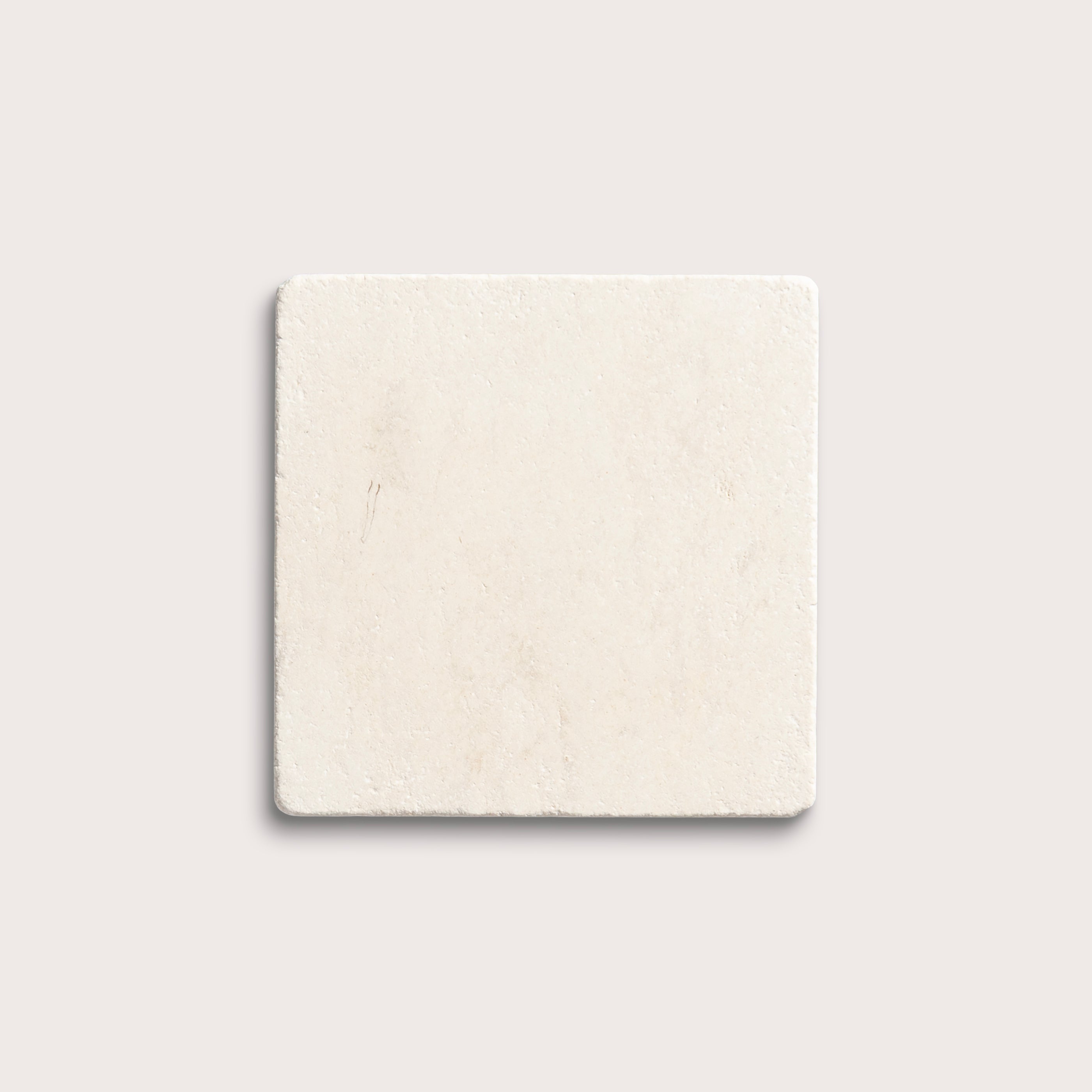 square tile with a beige limestone pattern on a white background