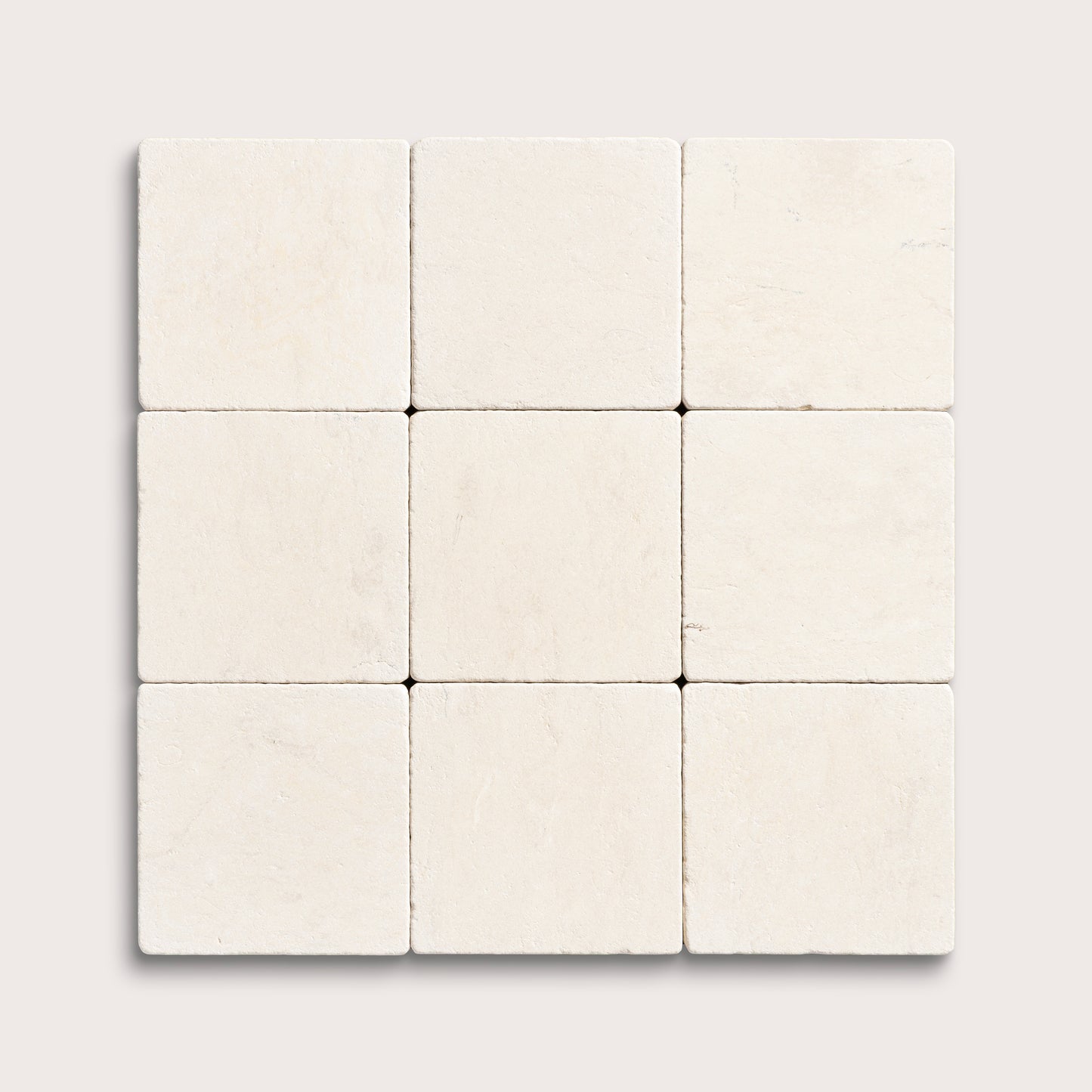 nine square tiles with a beige limestone pattern on a white background