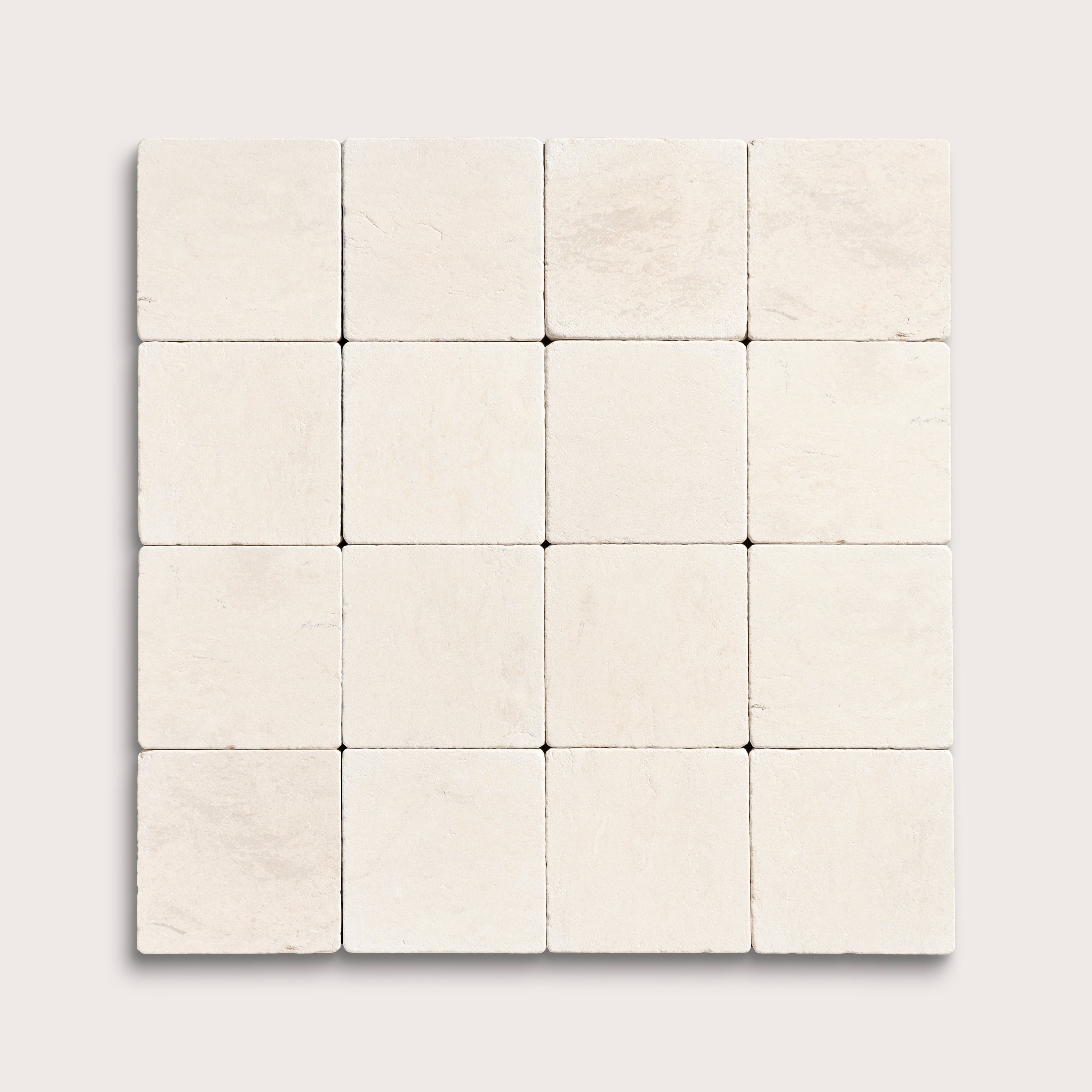 sixteen square tiles with a beige limestone pattern on a white background