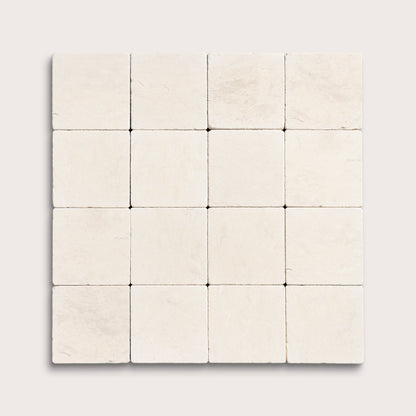 sixteen square tiles with a beige limestone pattern on a white background