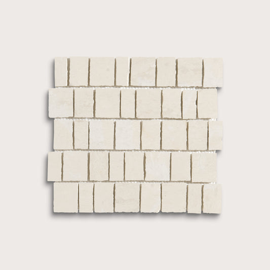 A square sample of small rectangular off-white stone mosaic tiles arranged in staggered rows on a light neutral background.