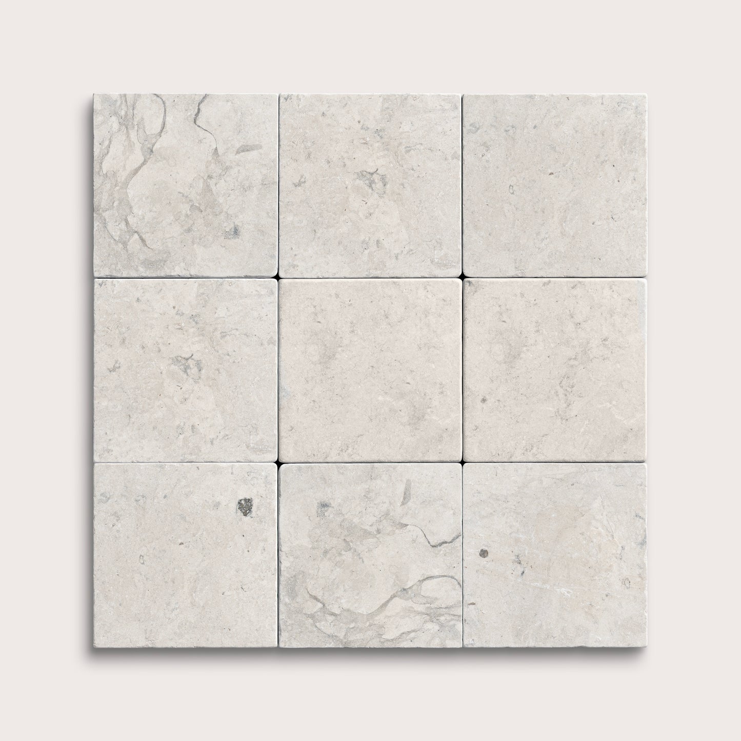 Nine square limestone tiles with a light gray marble pattern on a white background
