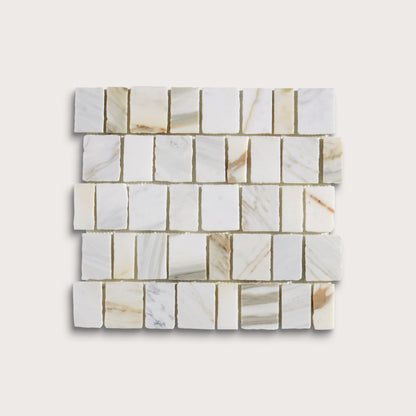 A square sample of white marble mosaic tiles with natural beige and light brown veining, arranged in a staggered brick pattern against a light beige background.