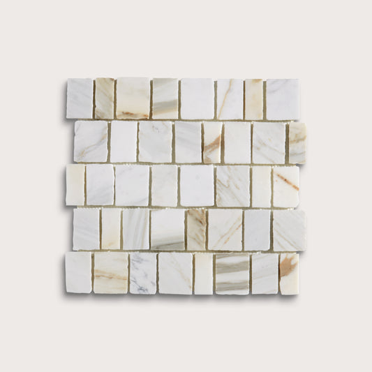 A square sample of white marble mosaic tiles with natural beige and light brown veining, arranged in a staggered brick pattern against a light beige background.