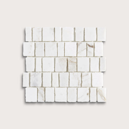 White marble rectangular mosaic tile sheet with natural veining, arranged in a staggered brick pattern on a light beige background.