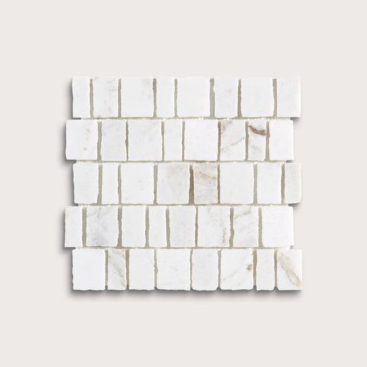 White marble rectangular mosaic tile sheet with natural veining, arranged in a staggered brick pattern on a light beige background.