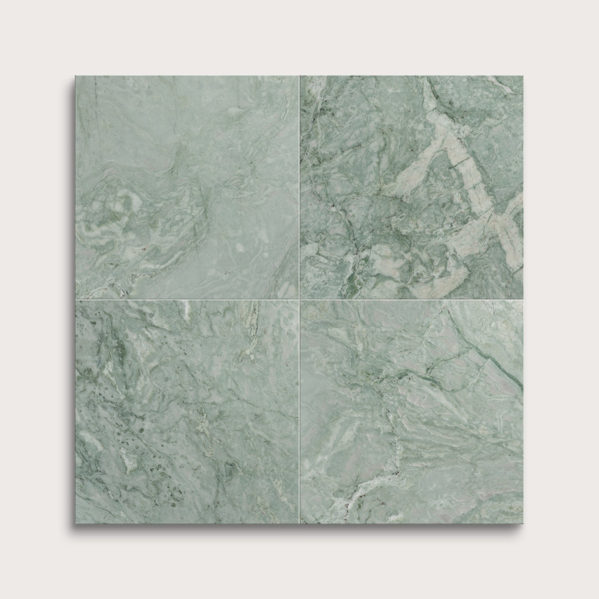 Four green marble tiles arranged in a grid pattern on a white background