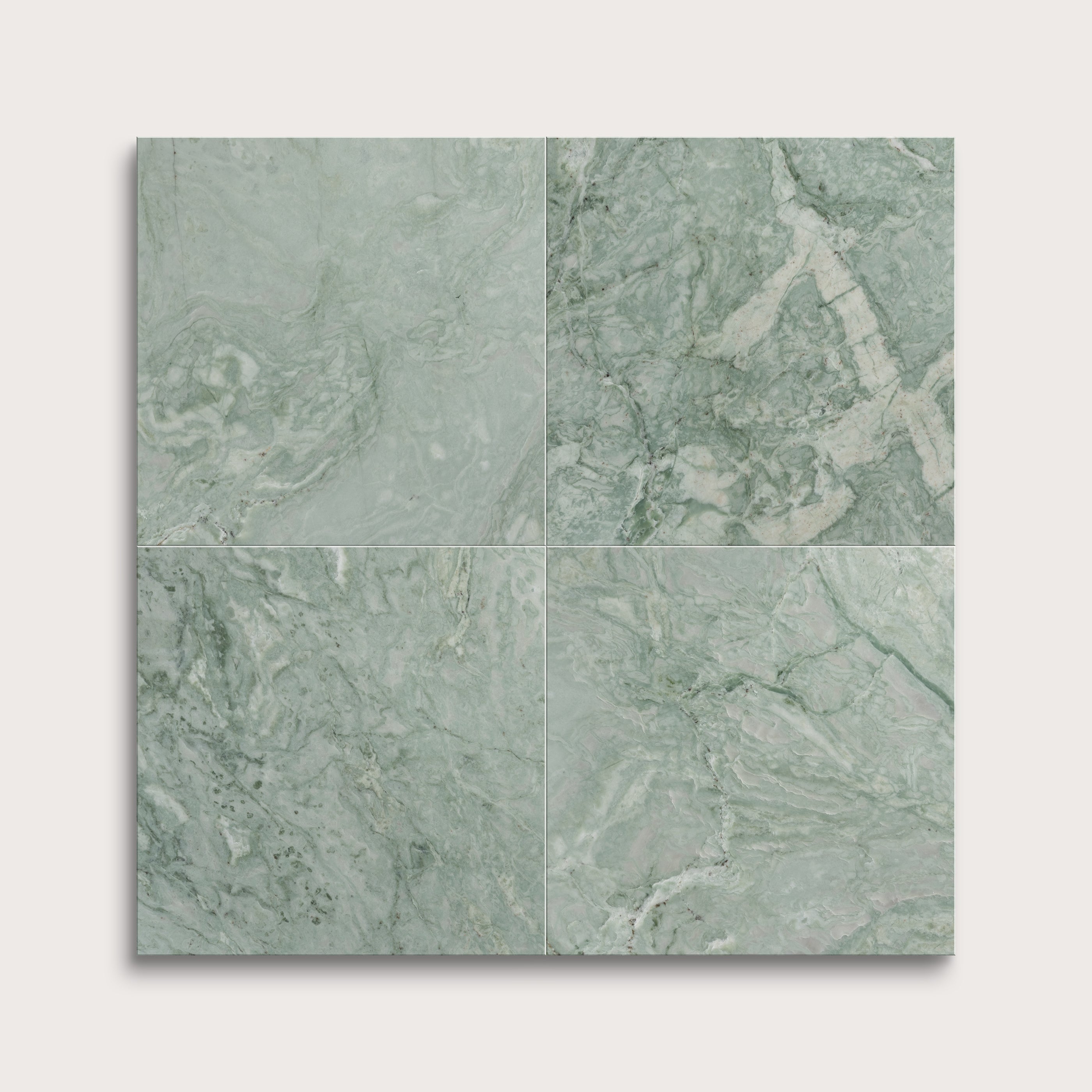 Four green marble tiles arranged in a grid pattern on a white background