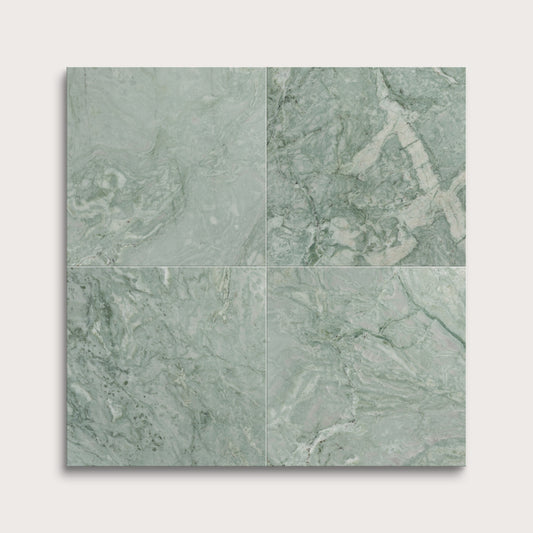 Four green marble tiles arranged in a grid pattern on a white background