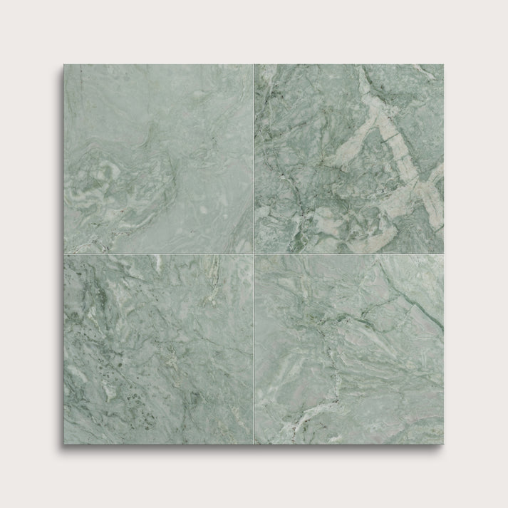 Four green marble tiles arranged in a grid pattern on a white background