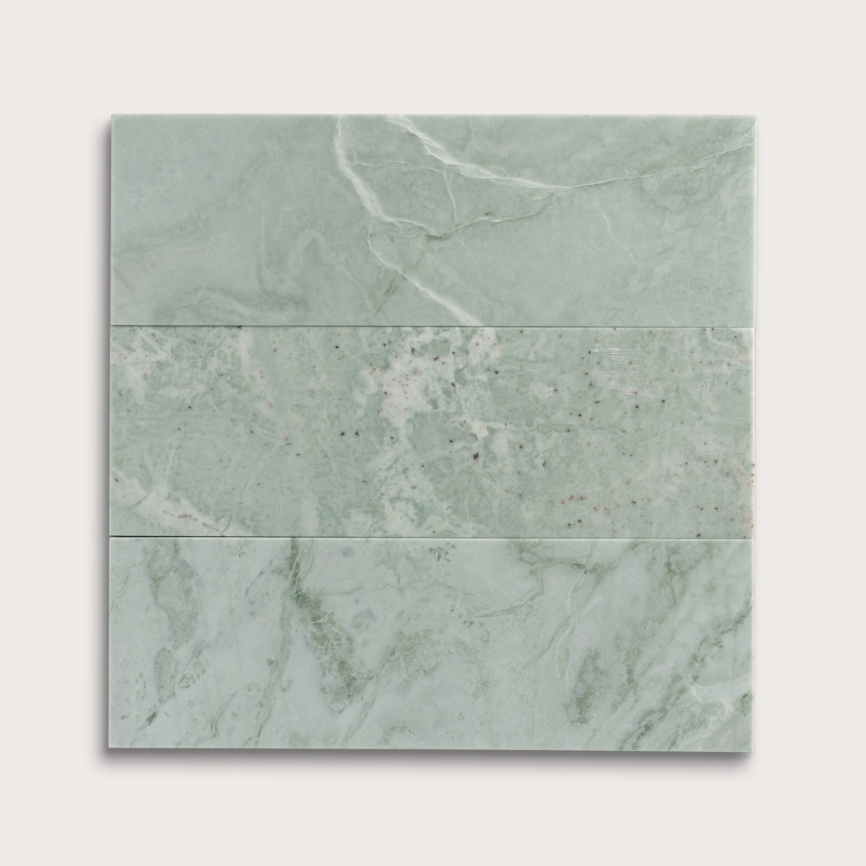 Set of green marble tiles on a white background