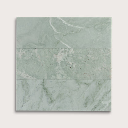 Set of green marble tiles on a white background