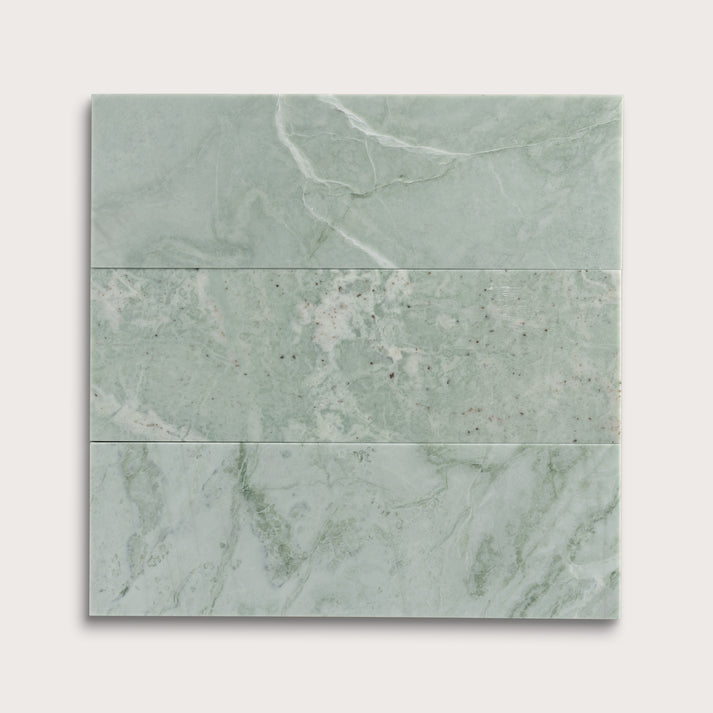 Set of green marble tiles on a white background