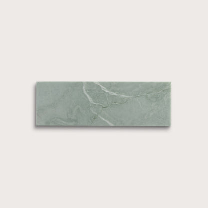 Rectangular green marble tile on a light gray background