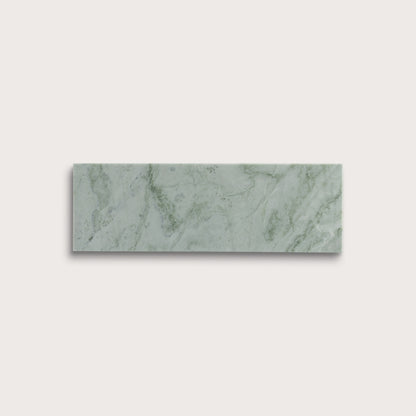 Rectangular green marble tile on a light gray background