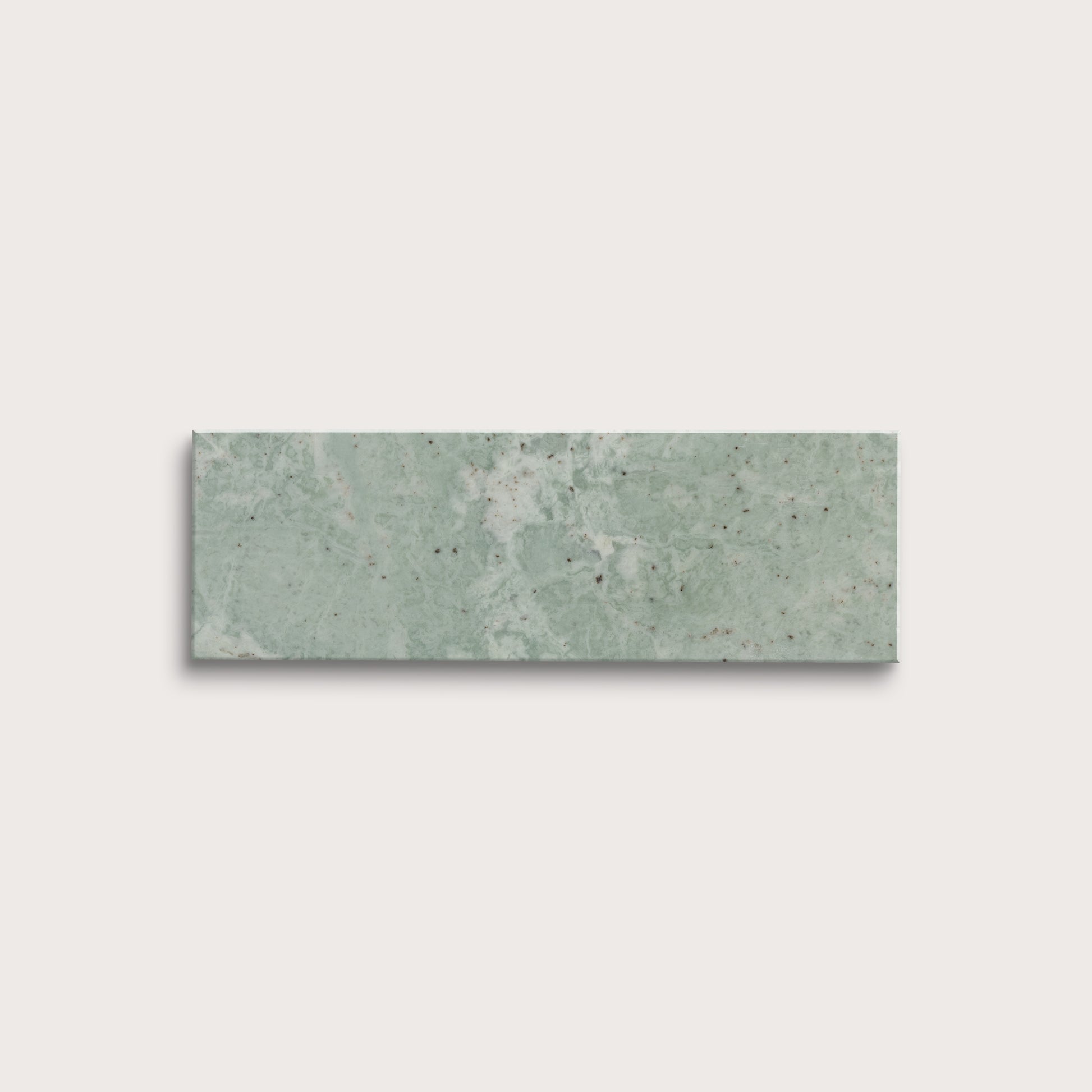 Rectangular green marble tile on a light gray background