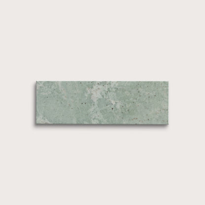 Rectangular green marble tile on a light gray background