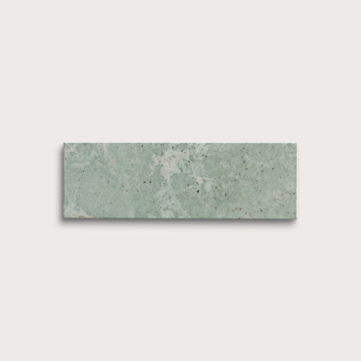 Rectangular green marble tile on a light gray background