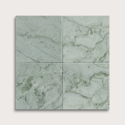 Four green marble tiles arranged in a grid pattern on a light gray background